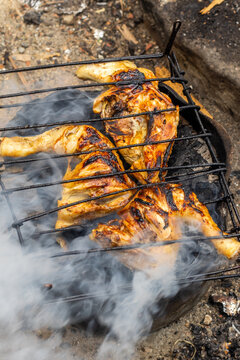 Grilled Chicken Pieces on an Outdoor Grill