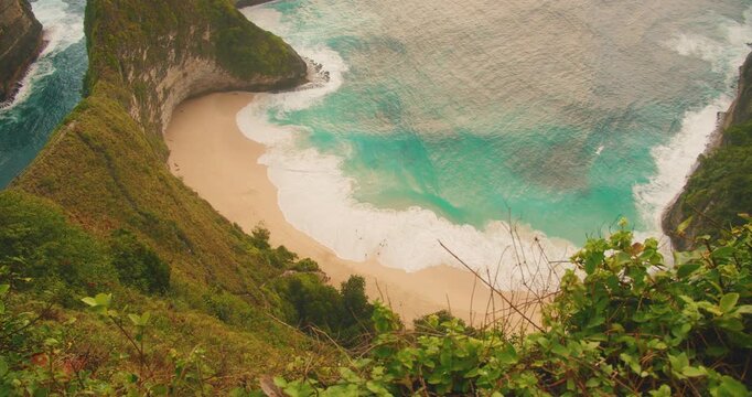 Scenic top down view of Kelingking Beach and turquoise ocean water in Indonesia Bali Nusa Penida