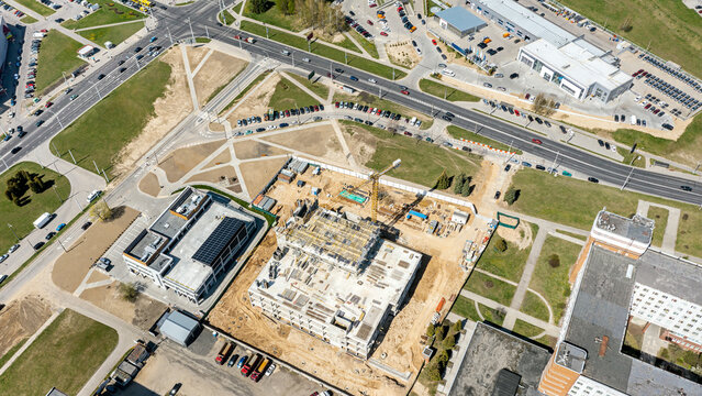 construction site in city residential area. new concrete building under construction. aerial view.