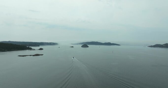 Aerial view of H&oslash;llen Norway coastal archipelago islands showing grey sky