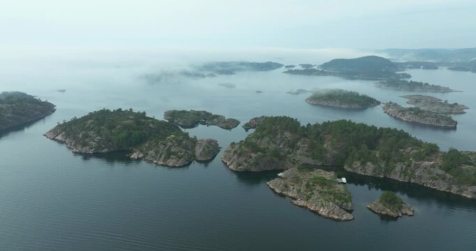 Aerial view of forested islands in Norwegian fjord waters showing high angle