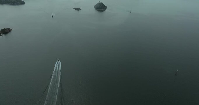 Aerial view of H&oslash;llen Norway coastal archipelago islands in slow motion showing water