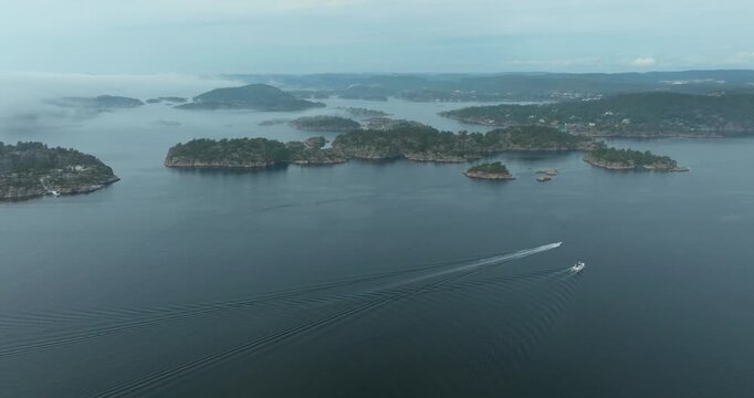 Aerial view of H&oslash;llen Norway coastal archipelago islands in slow motion showing maritime