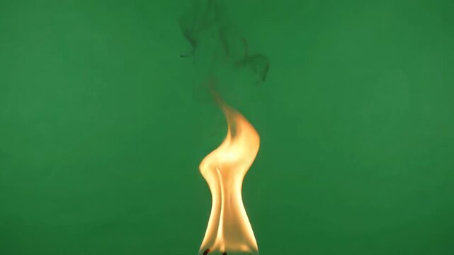 Realistic fire flame on green screen, flickering orange campfire element, isolated burning heat effect for vfx compositing