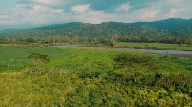 Aerial view of Tarcoles River winding through tropical green hills in Costa Rica