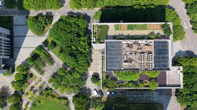 Aerial view moving over a green rooftop garden and building