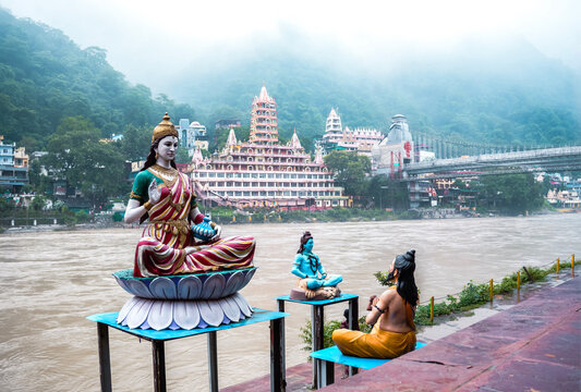 Statue of Goddess Parvati on the Ganges Riverbank with Trimbakeshwar Temple in Background, Rishikesh, Uttarakhand, India