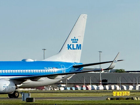 Amsterdam, Netherlands - July 6 2026: A KLM aircraft is parked on the tarmac. The tail of the plane shows the airline logo.