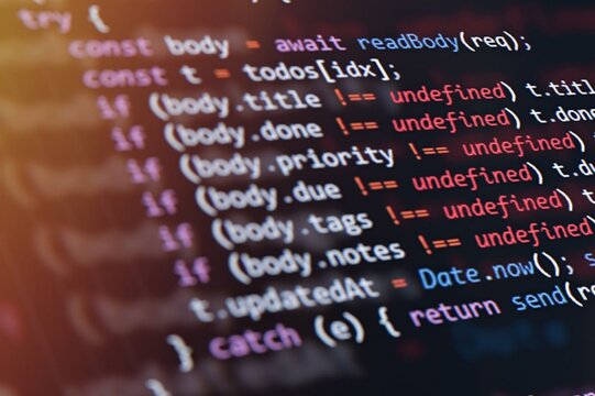Code glows softly on a screen, showing programming logic. Fingers never appear, but focus is clear. Lines check values, date, and data state. Soft focus highlights key lines in a warm glow