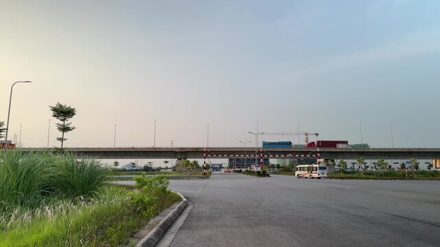 Wide view of a bridge with container trucks traveling across in Hai Phong, Vietnam, showing road infrastructure and freight traffic.