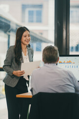 Business professionals collaborating on project, analyzing market data and financial charts on...