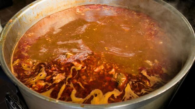 Birria cooking footage showing showing off birria soup during the traditional Mexican birria cooking process