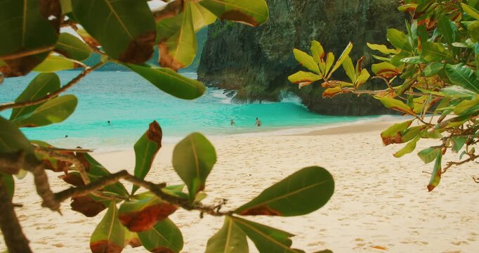 Blue ocean water on sandy shore of Kelingking Beach in Nusa Penida Bali