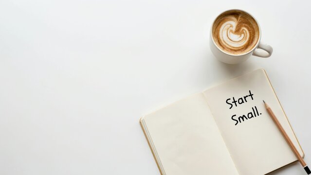 Open notebook with start small text, pencil, and cup of coffee on white desk