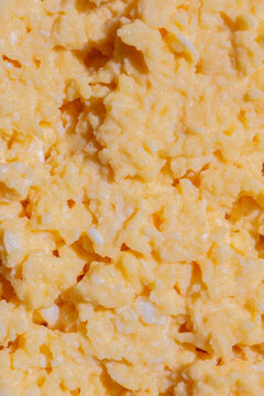 Organic scrambled egg, made with chicken eggs, butter and milk, background backdrop. Healthy breakfast food concept.