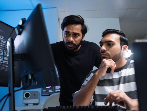 Team engineers software development are brainstorming using computer writing code. Programmer teamwork meetings using technology artificial intelligence work system about cyber security and coding 