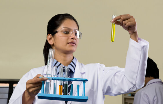 Girl holding a test tube with a chemical 