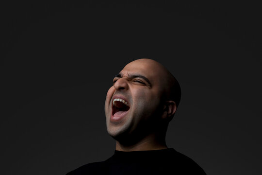 Bald man screaming 