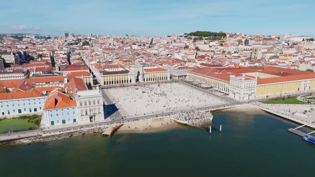 Slow panning drone shot of Praca do Comercio and Rua Augusta Arch, Lisbon at noon. Portugal
