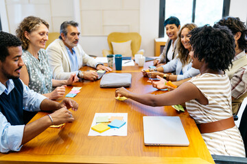 Fototapeta premium Professionals engaging in a productive coworking meeting, sharing ideas and planning strategy using sticky notes for project development