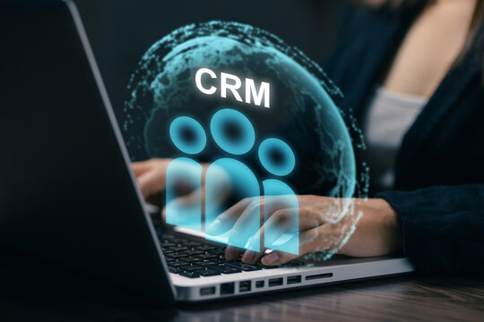 Businesswoman using laptop with CRM customer management interface, representing client data, relationship management, digital marketing, sales technology, and business communication.