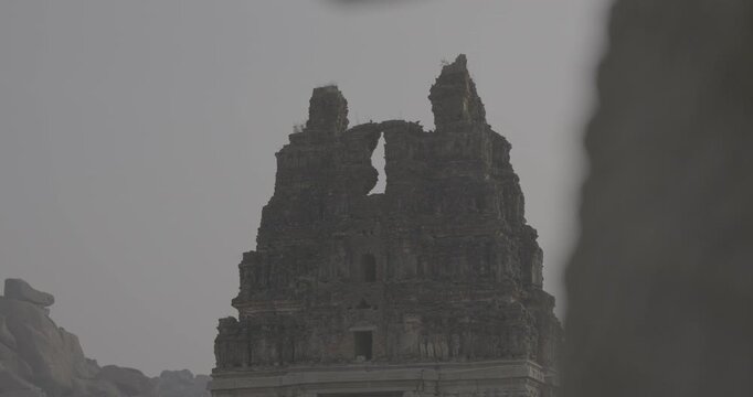 Silhouette of ancient temple Gopuram entrance tower at dusk in Hampi