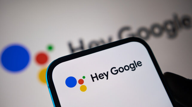 Hey Google voice assistant logo on smartphone display for smart home technology and artificial intelligence interaction.