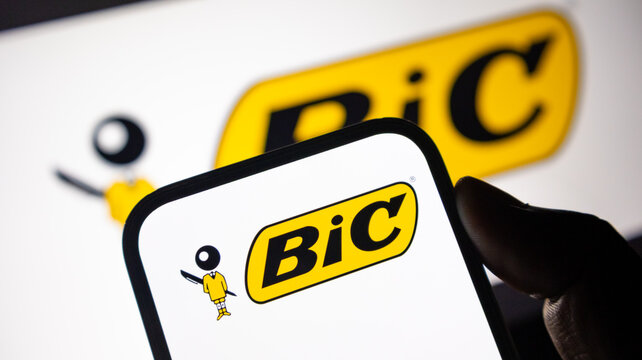 Bic stationery brand logo on smartphone screen with iconic yellow design for office supplies and writing instrument news.