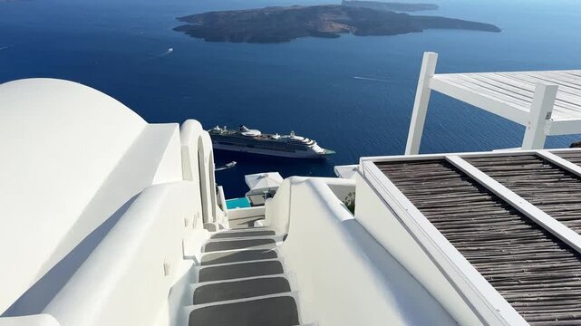 White architecture in Santorini island, Greece. Steps to the sea. Blue sea and the blue sky at sunset. Travel and summer vacation concept. 
