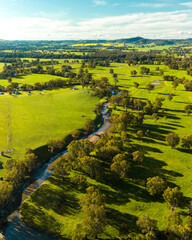 Naklejka premium Aerial View of Landscape with Green Fields and Hills