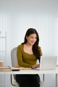 Portrait of confident Asian businesswoman working in office