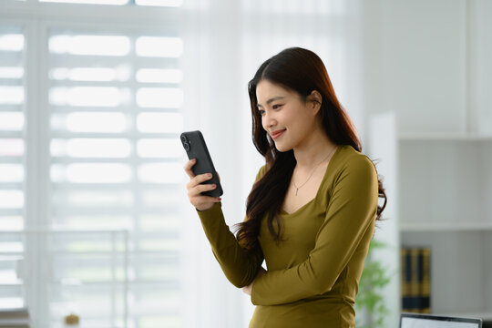 Woman using smartphone online searching on internet