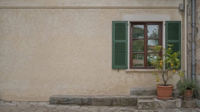 Repaired wooden shutters on a European house facade - insurance claim - copy space