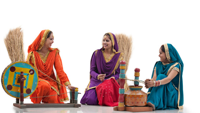 Women with a spinning wheel and a butter churner 