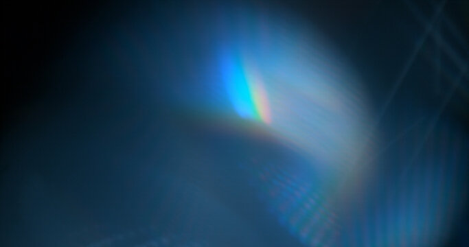 Abstract cinematic lens flare with soft bokeh circles and subtle light reflections. Atmospheric optical effect background ideal for overlays, visual effects, film production and creative design.