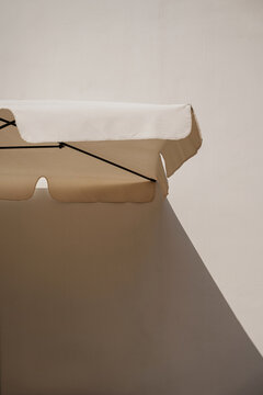 Umbrella's Sunshade Casting Shadow on Wall