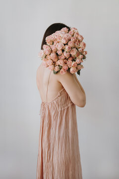Woman Holding Bouquet of Pink Roses Flowers