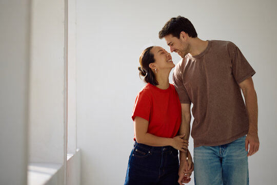 Happy multiracial couple in love looking at each other.