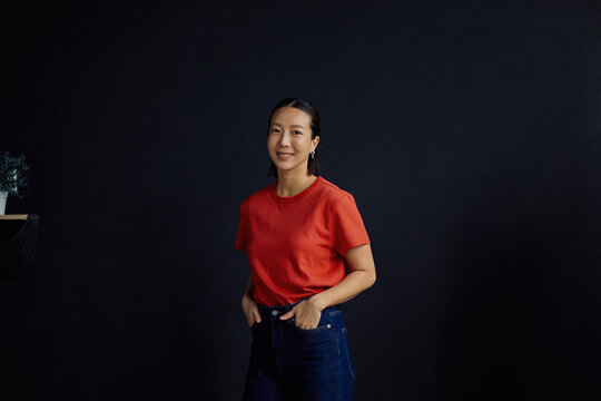 Portrait of smiling Korean woman looking at camera.