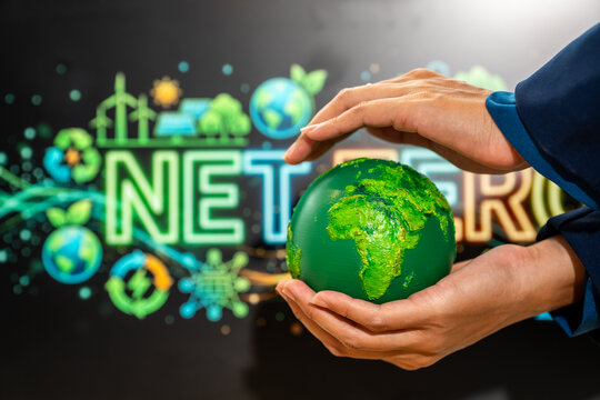 Hands holding a green earth sphere with a sustainability network in the background