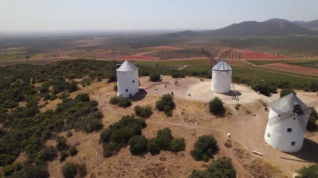 Aerial view of historic windmills in Puerto Lapice, Spain, immortalized by Cervantes in Don Quixote on a sunny day