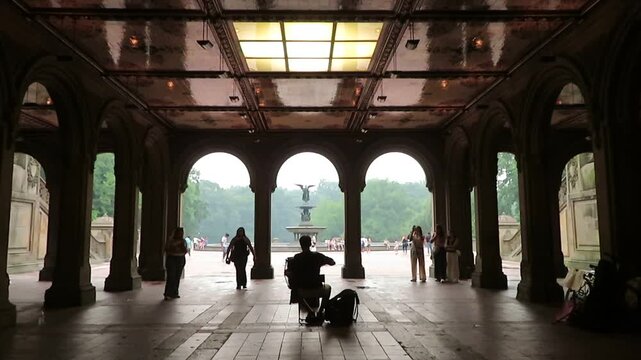 video of a street musician plating in the Bethesda terrace with the view of the fountain in New York city