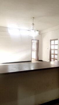 An empty minimalist living room space with bar aesthetics, pan left close-up shot vertical video 4k, liminal environment for backgrounds
