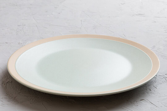 Perspective view of empty light plate on cement background. Empty space for your design