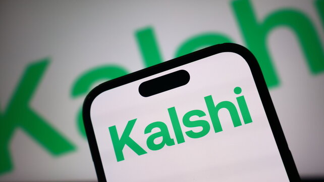 Kalshi logo branding displayed on modern smartphone screen with green corporate text against white backdrop for digital trading platform.
