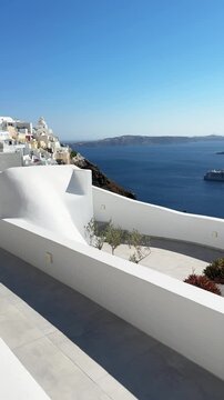 White architecture in Santorini island, Greece. Blue sea and the blue sky at sunny day. Panoramic view of the island. Travel and summer vacation concept. Vertical video
