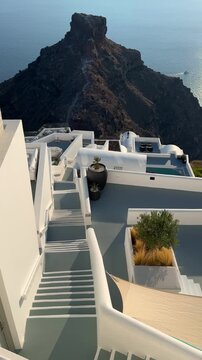 Beautiful sunset in Santorini island, Greece. White architecture with sea view. Blue sea and the blue sky at sunset. Summer travel and vacation. Vertical video
