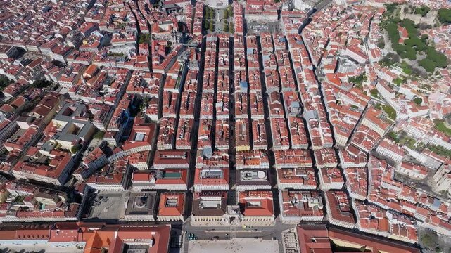 Stunning aerial shot showcasing Praca do Comercio and Rua Augusta Arch in Lisbon, Portugal. Vibrant red rooftops, grid-like city layout, and bright, clear daylight. Portuguese Architecture.