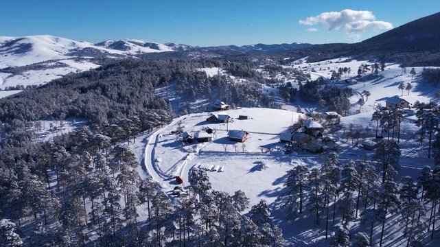 Drone Shot of Winter Landscape, House and Farm on Hill, Snow Capped Forest on Sunny Day