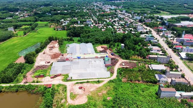 In Duc Linh, Lam Dong, Vietnam, take in the views from above. Explore the landscape with fields, buildings, and water bodies in this vibrant area. Experience the scene from different angles.